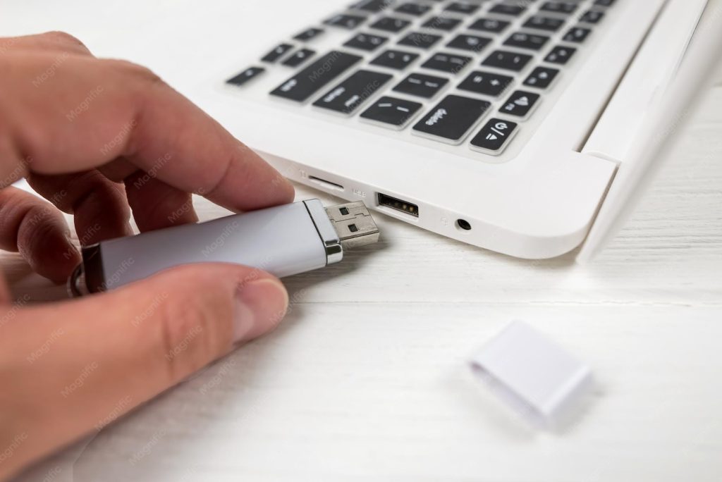 wifi password recovery software portable Person inserting USB flash drive into a laptop, close up of USB port